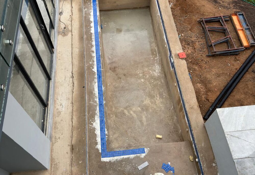 Terraced concrete steps and boundary wall during construction