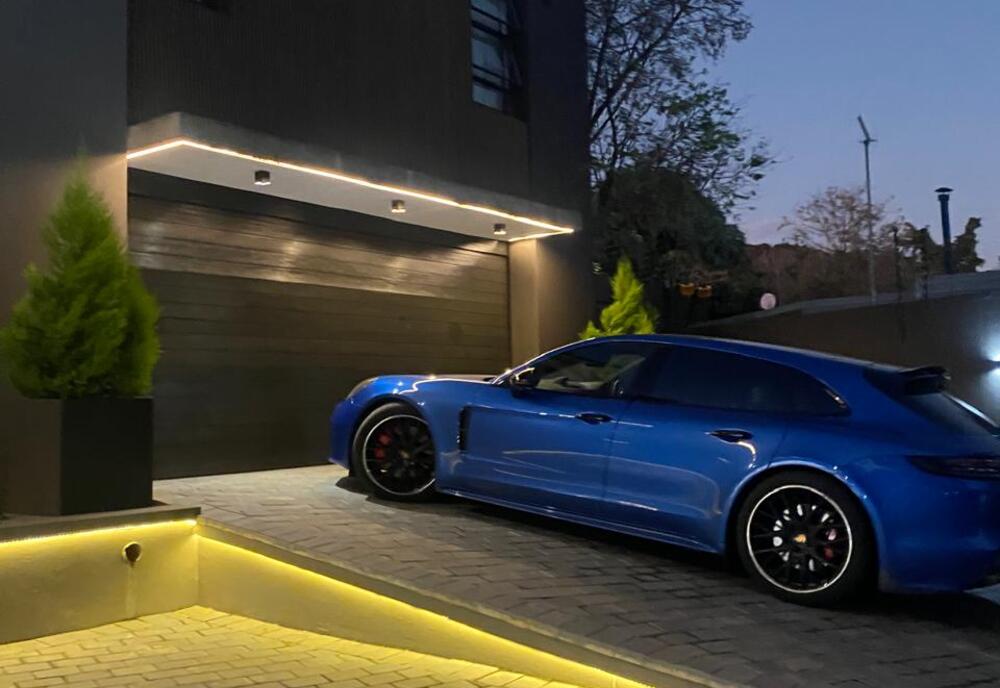 Paved driveway with feature LED lighting at dusk