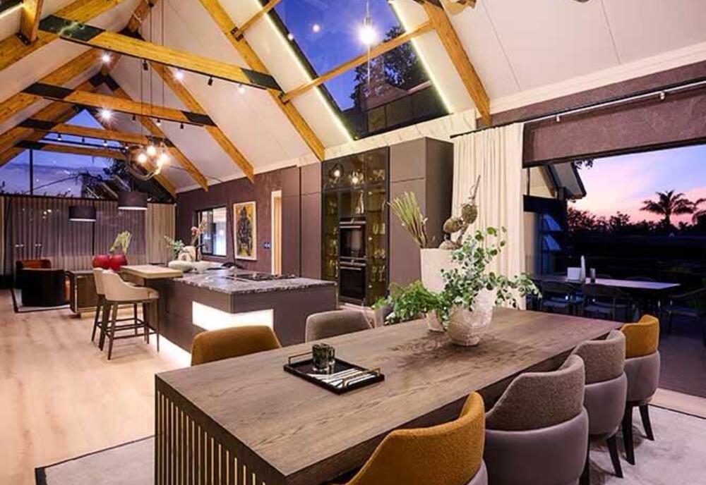 Vaulted living and dining space with exposed timber beams